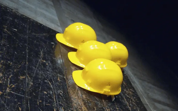 Hard hats on a floor in yellow color