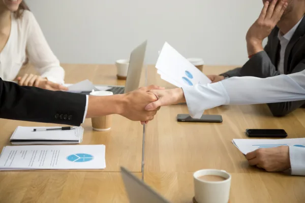 Handshake symbolizing trusted partnership in financial fraud investigations