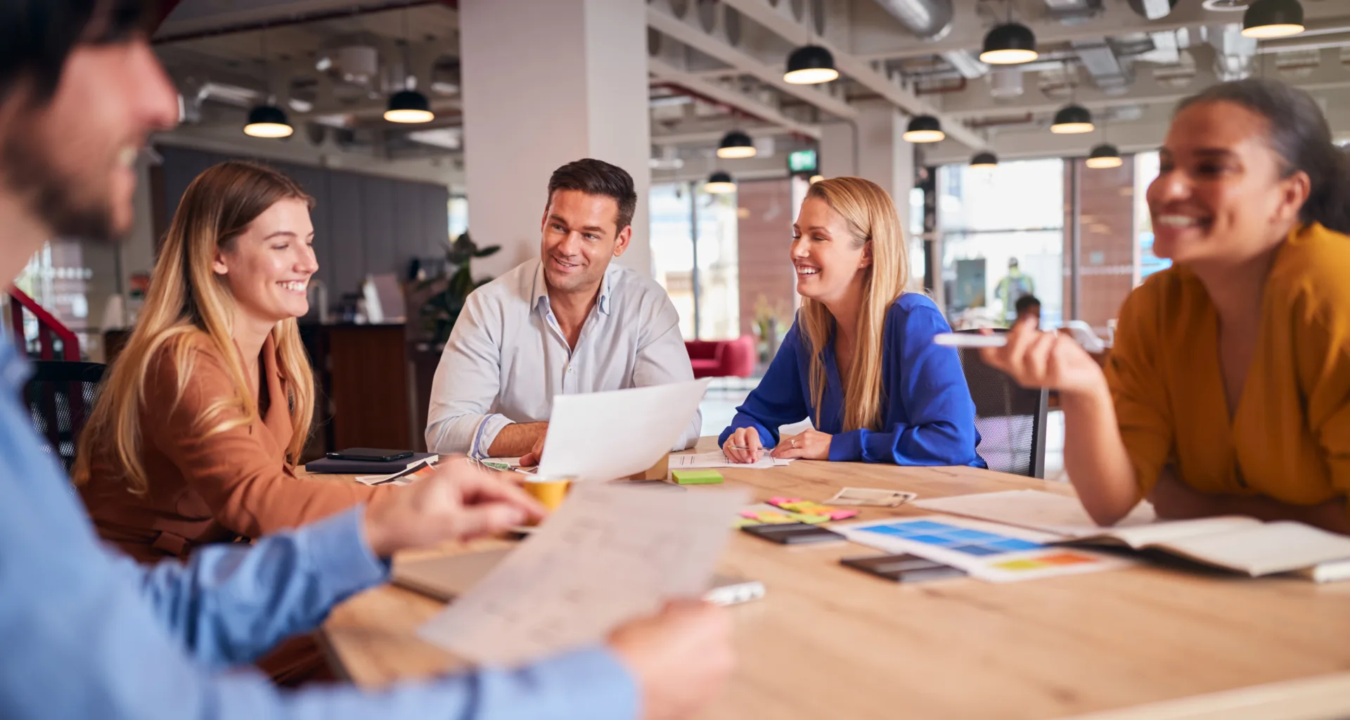 Professional team collaborating around a conference table, symbolizing thorough background screening