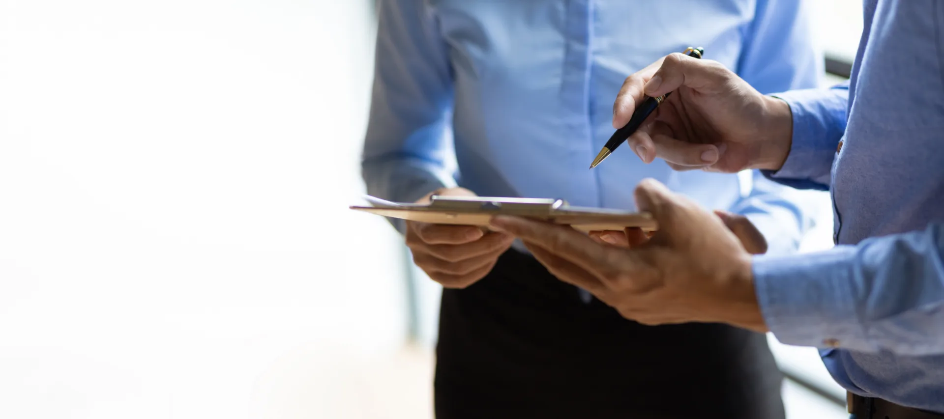 Compliance checklist on a clipboard with a pen, representing proper background screening standards